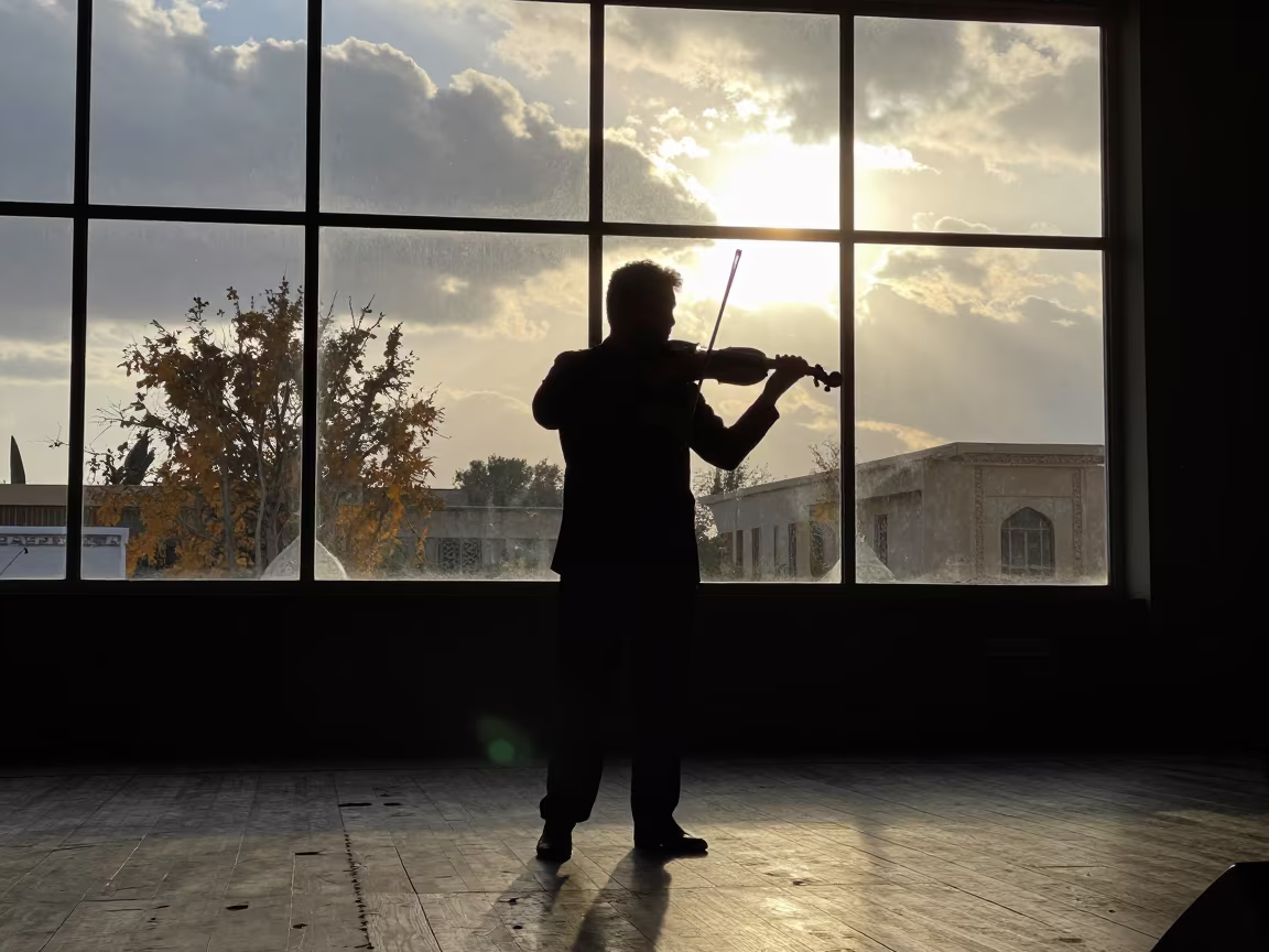 Silhouetted Violinist on Kandahar Stage in on a theater stage in Kandahar