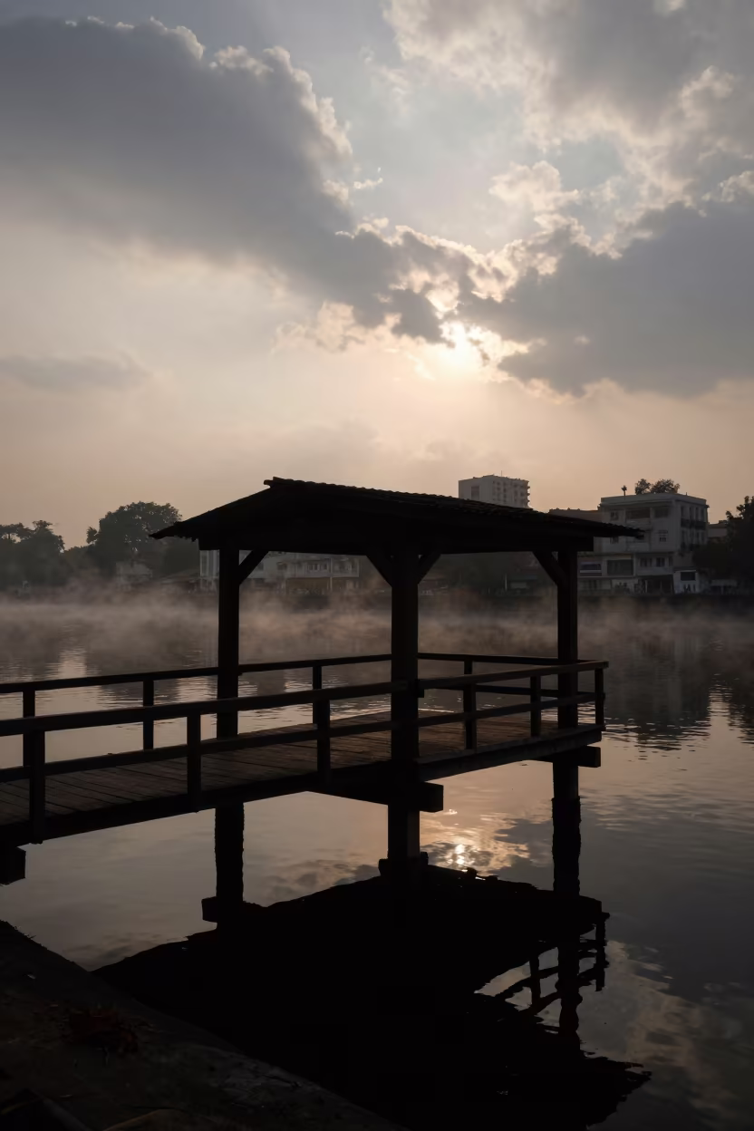 Silhouetted Wooden Pier at Sunset Over Delhi Canal in beside a canal-front facade near Lajpat Nagar, Delhi