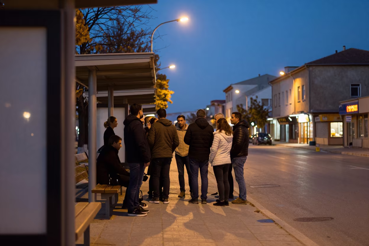 Silopi Bus Stop Queue Under Sodium Light in along a shuttered arcade in Silopi