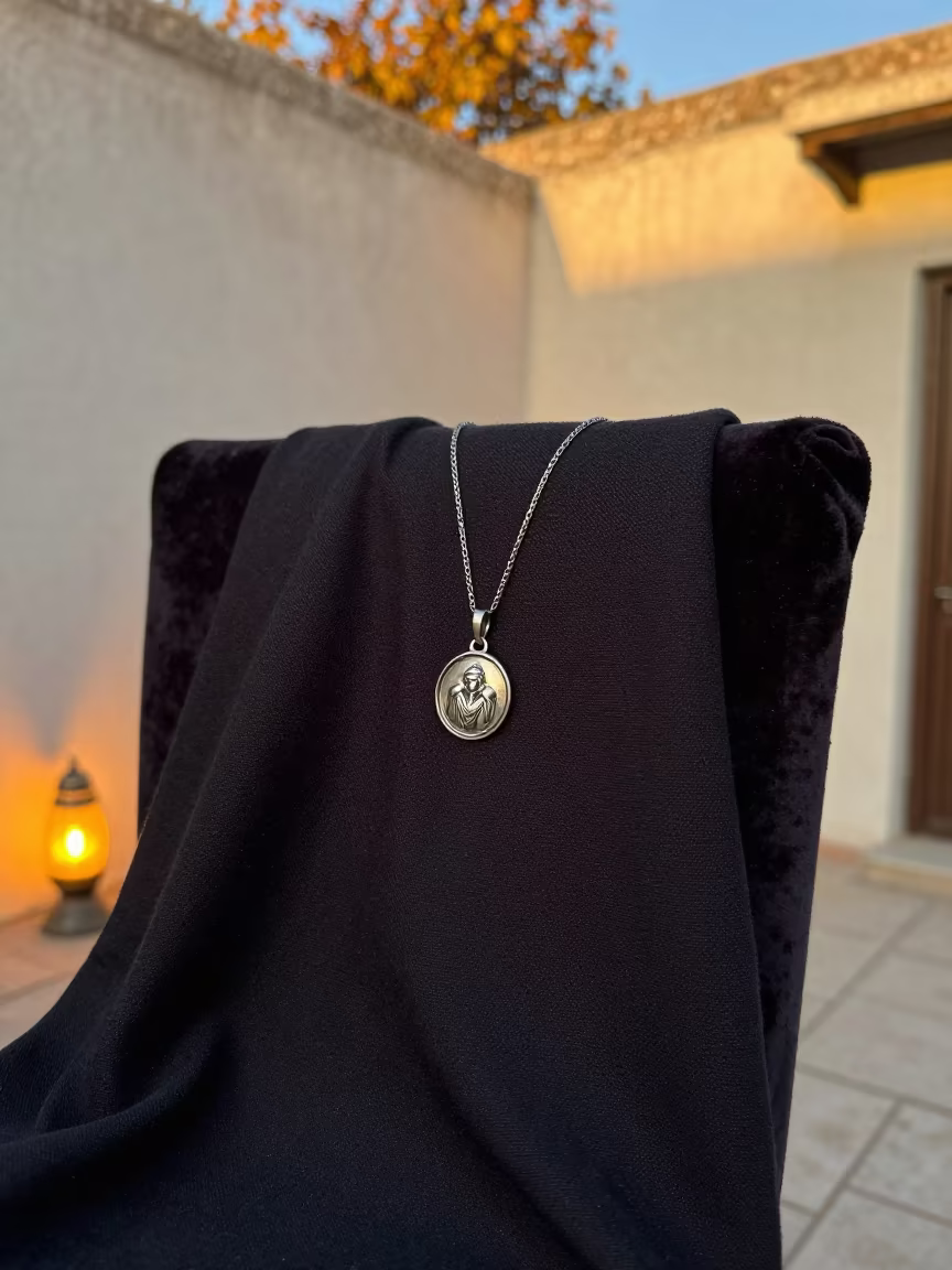Silver Amulet on Dark Linen in Ghardaia in on a velvet chair in Ghardaia