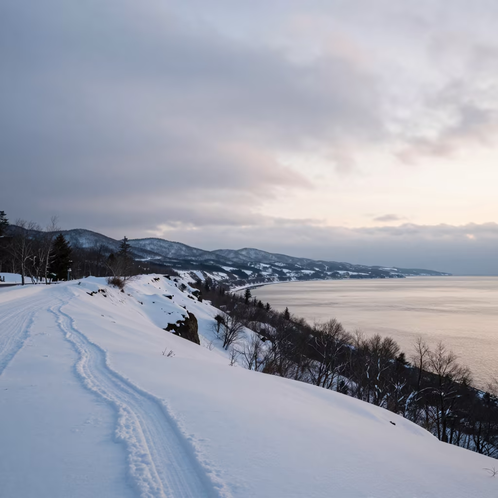 Silver Dawn Light Over Snow Dusted Sapporo Cliffs in from a ridge above layered foothills near Sapporo