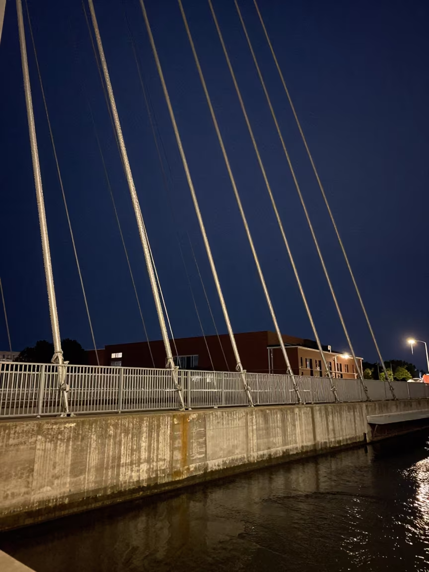 Silvery Bridge Cables Against Summer Night Sky in beside a canal-front facade in South Dakota