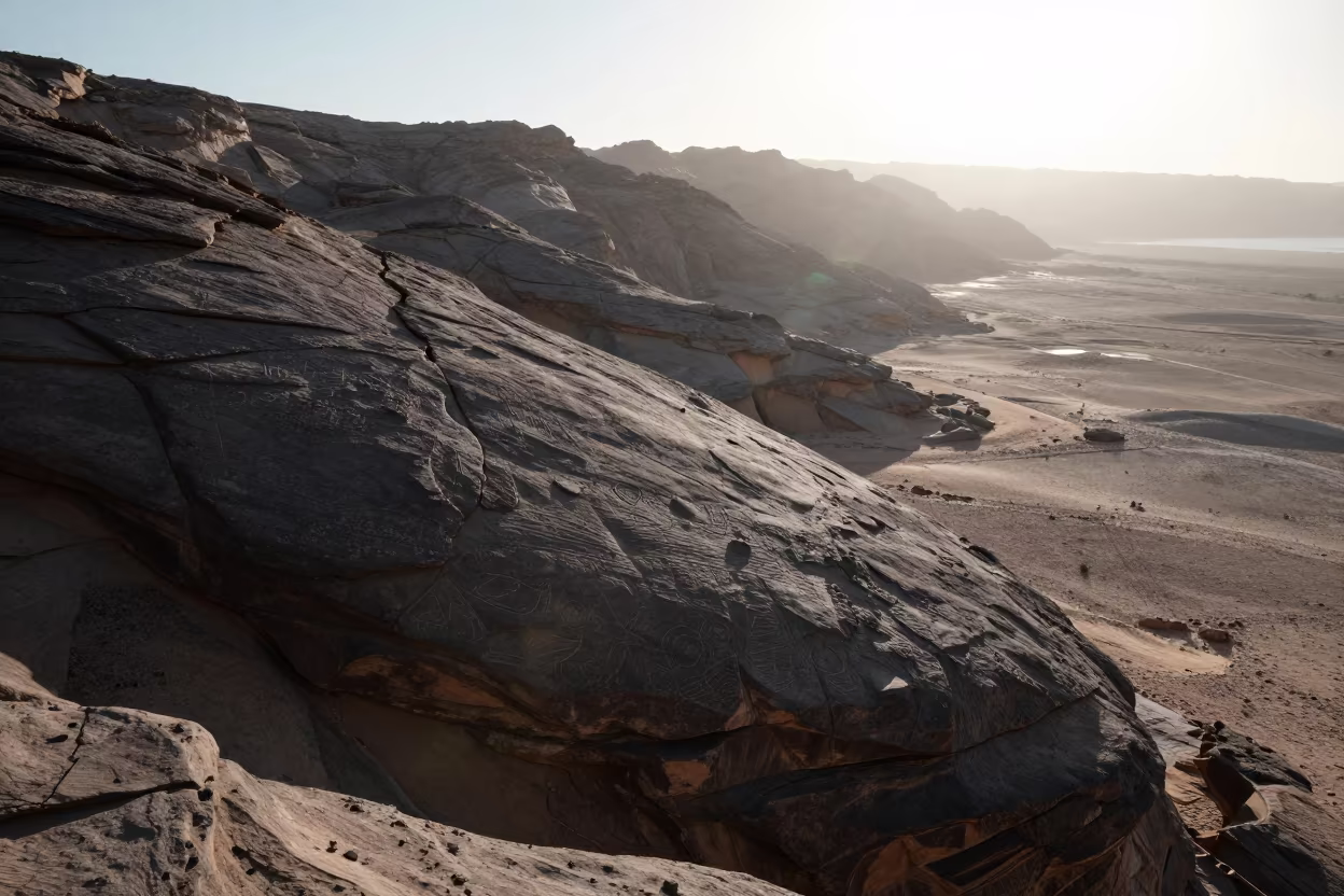 Sinai Cliff Petroglyphs Under Hard Coastal Glare in from a ridge above layered foothills in Sinai