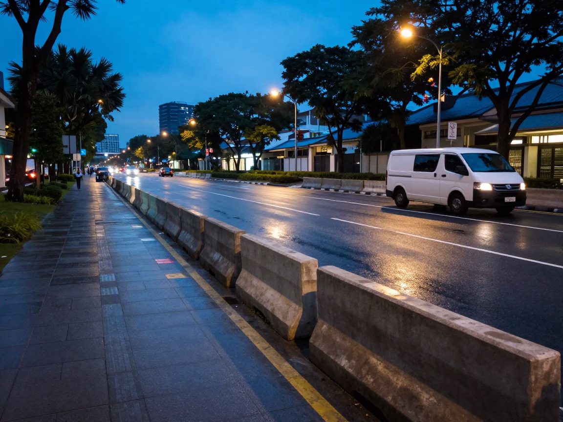 Singapore evening street scene with concrete barriers and distant skyline under blue light in in Singapore, Singapore