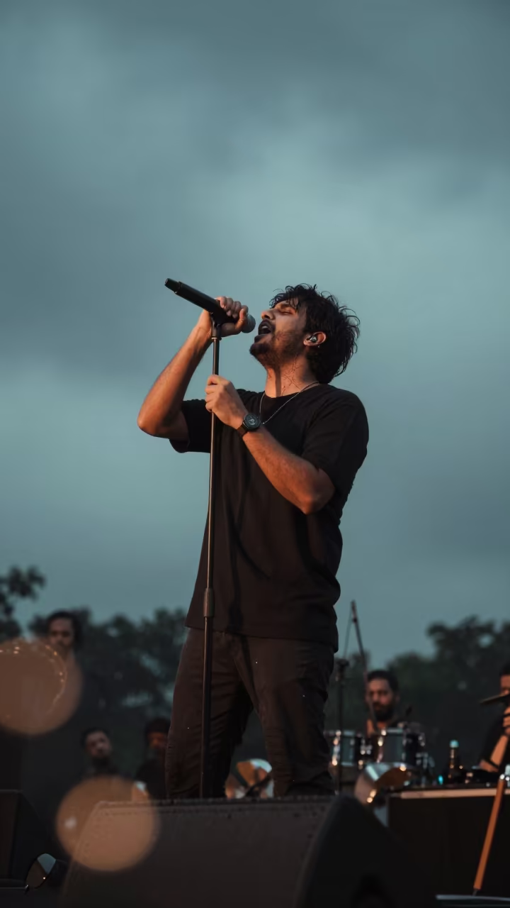 Singer Belting Note on Pune Stage Twilight in on a dimly lit stage in Pune