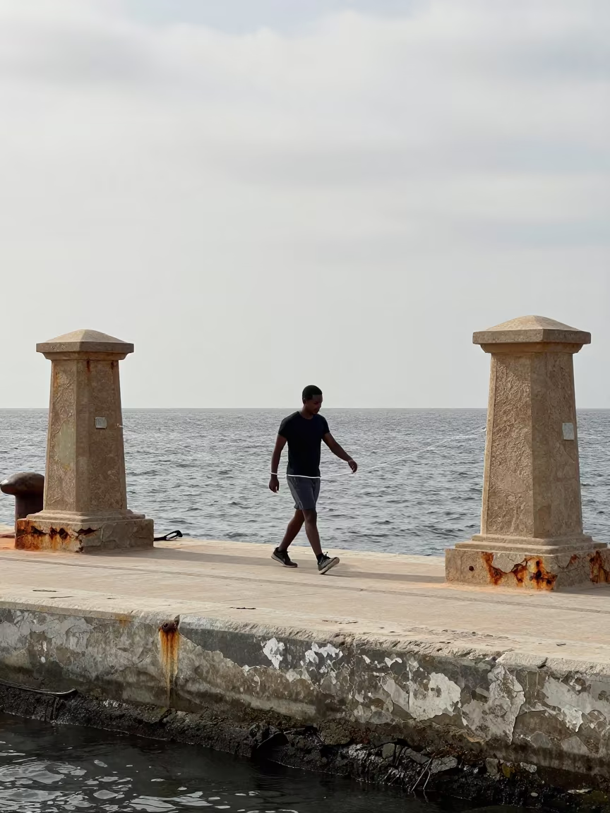 Slackliner Tension Between Cairo Harbor Walls in at a harbor quay near Cairo