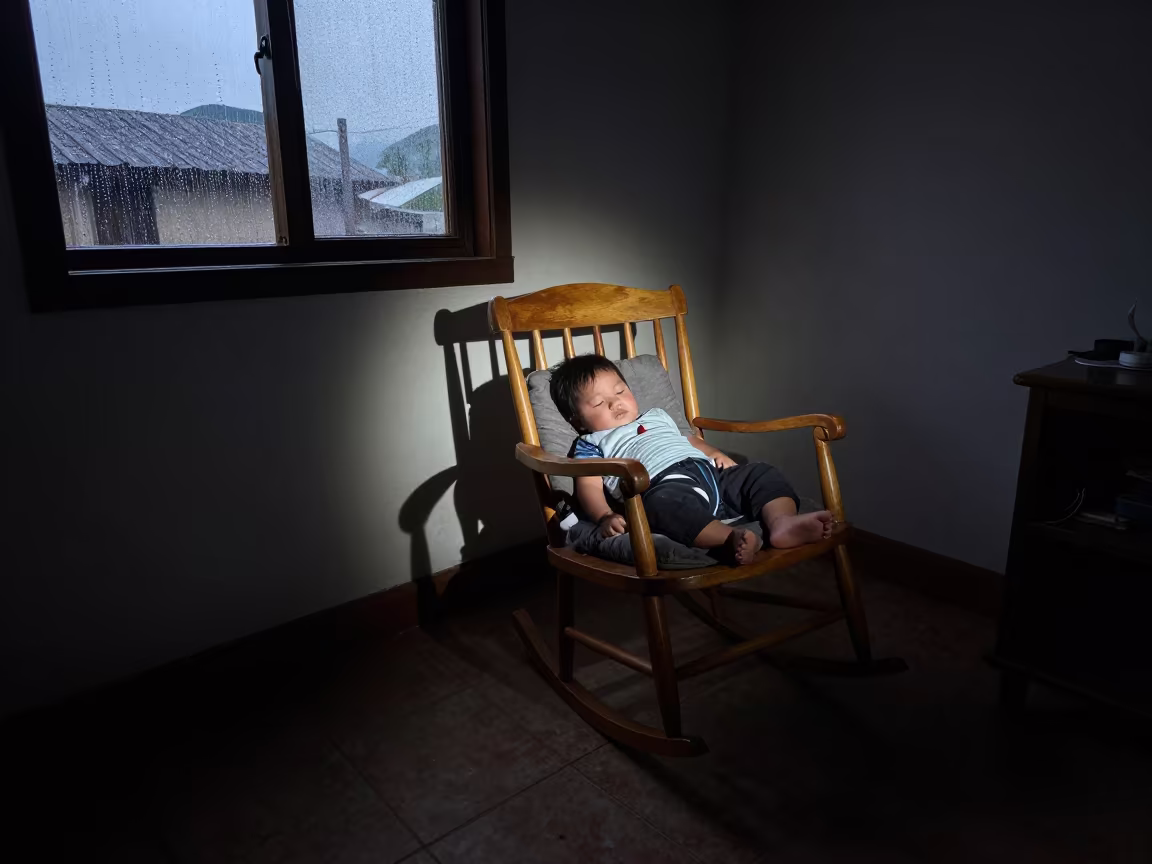 Sleeping Baby in Rocking Chair Before Dawn in in a sunlit living room in Chimbote