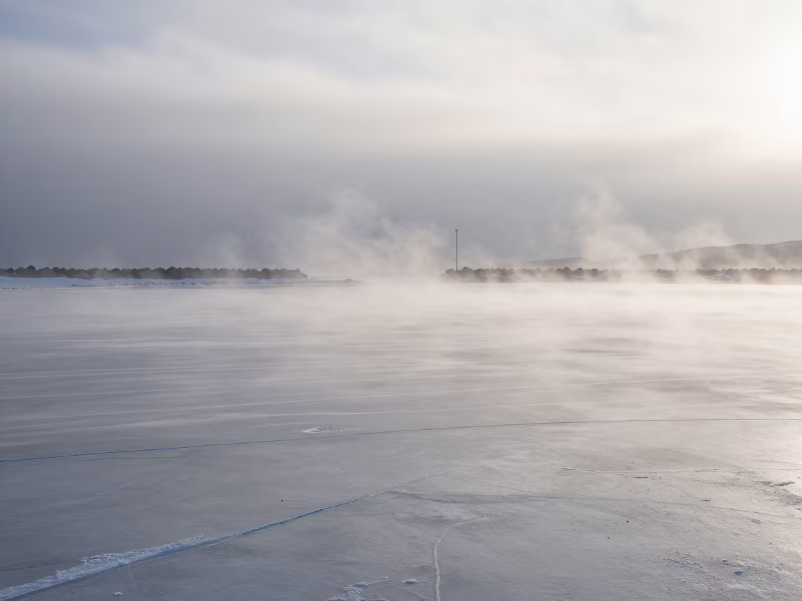 Snow Squall Sweeps Frozen Harbor Near Sapporo in across a storm-bright plain near Sapporo