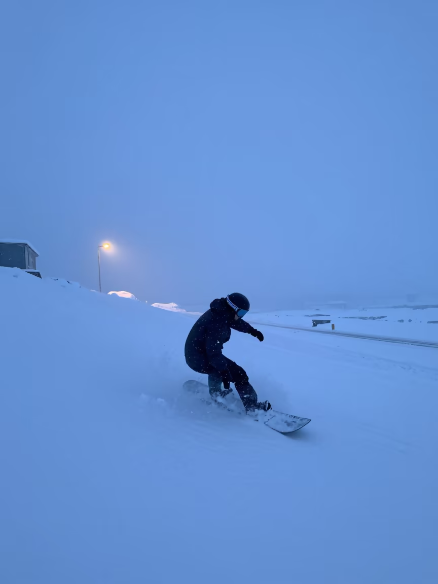 Snowboarder Carving Turn in Icelandic Winter Mist in at a roadside stop near Reykjavik