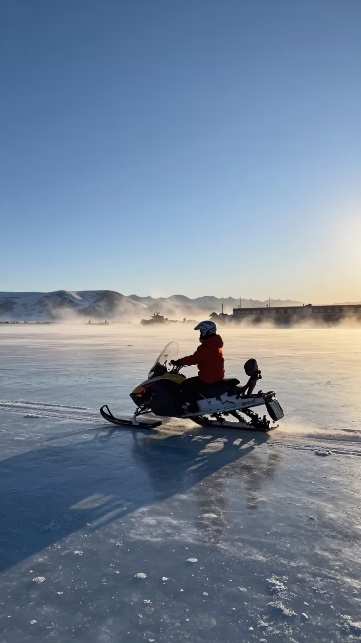 Snowmobile Crosses Frozen Lake Before Dawn in beside a fogbound harbor mouth in Tibet