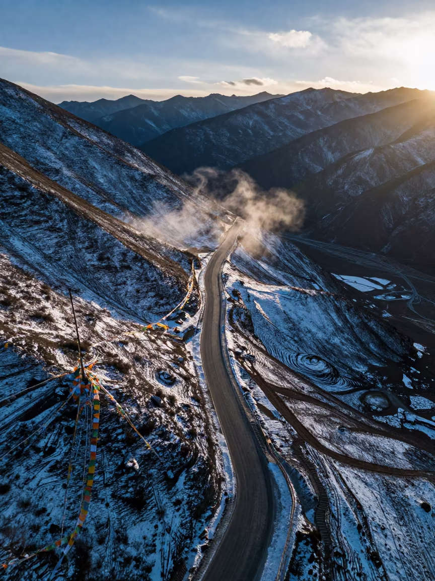 Snowy Mountain Pass Road Zigzag Silhouette in along a high mountain pass beneath prayer flags near Lhasa