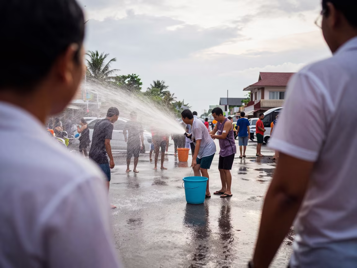 Songkran Reveler Sprays Water at Phuket Waterfront in at a waterfront celebration near Phuket