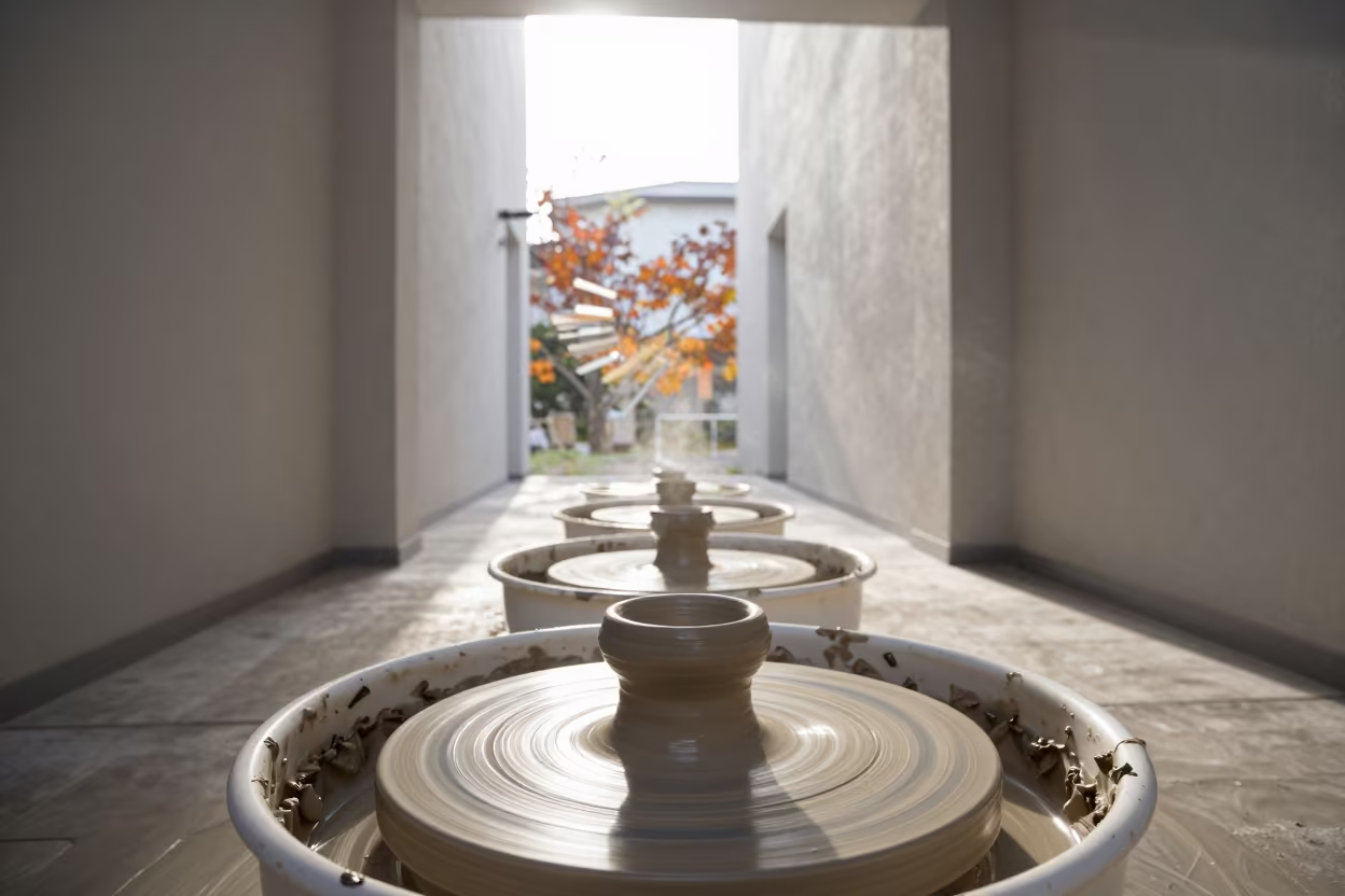 Spinning Pottery Wheel Motion Blur Autumn Light in inside a skylit passageway in Okayama
