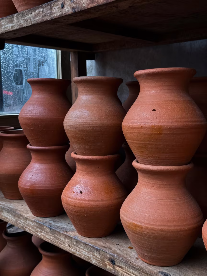 Stacked Clay Wares on Wooden Shelf in on a wooden shelf inside a covered market in Gorakhpur