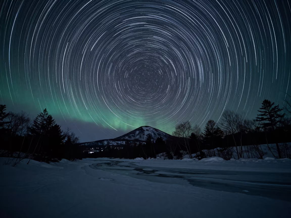 Star Trails Wheel Over Frozen River Bend in from a quiet alpine saddle near Sapporo
