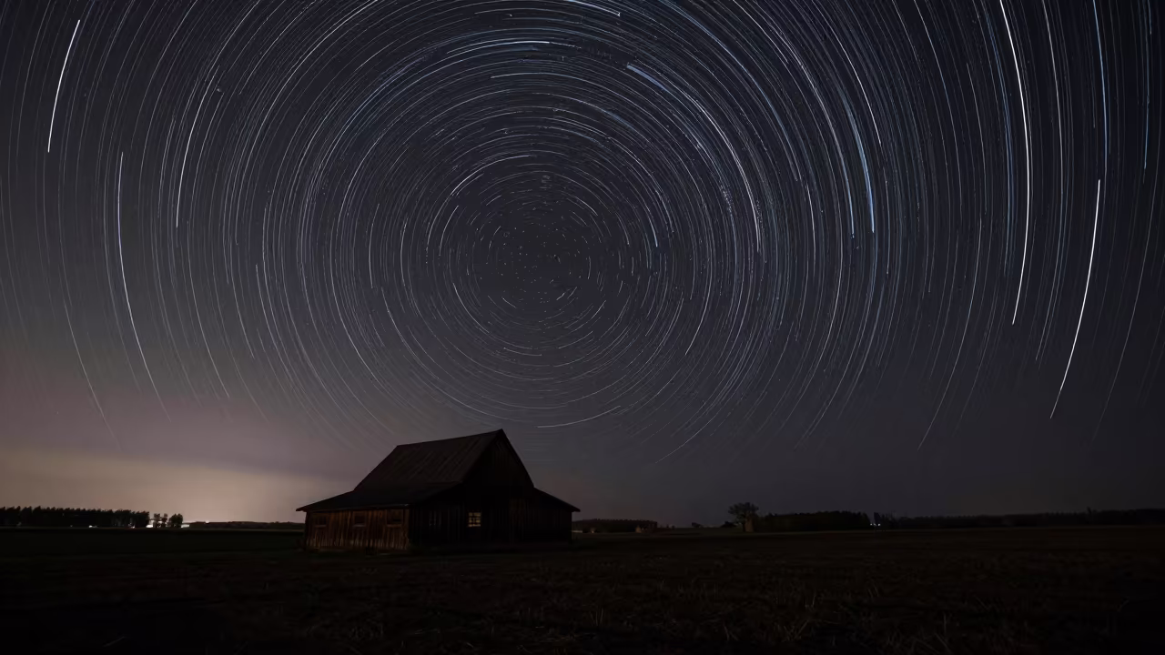 Star Trails Over Belarus Barn Night Sky in beneath a dark-sky overlook in Belarus
