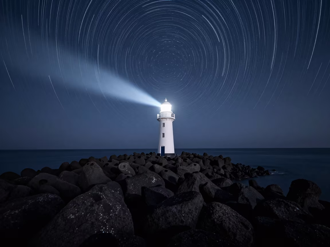 Star Trails Over Lighthouse on Black Cliffs in from a moonlit breakwater in South Korea