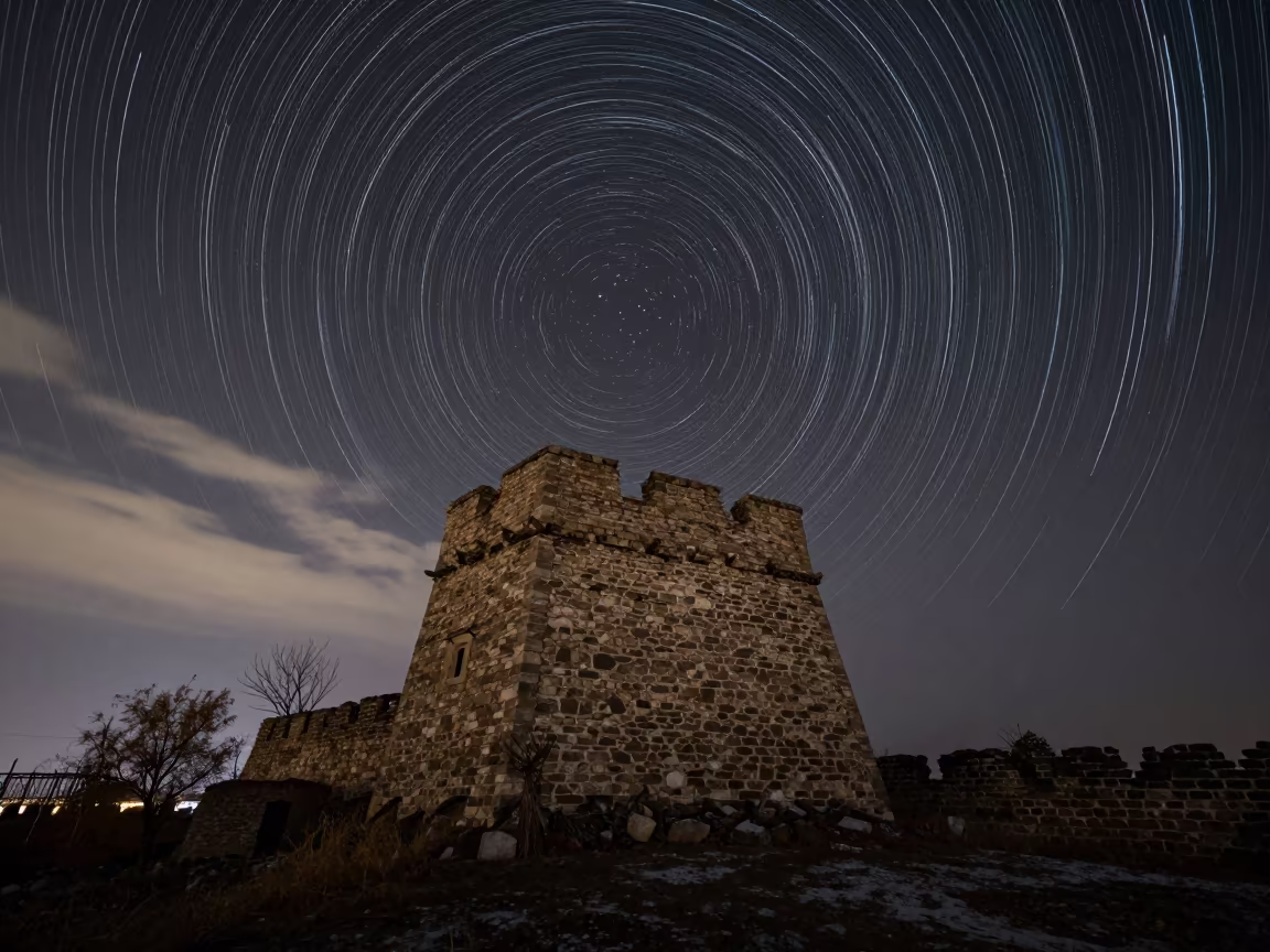 Star Trails Spiral Over Ancient Tower in Liaoning Night in beneath thin cloud gaps and stars in Liaoning