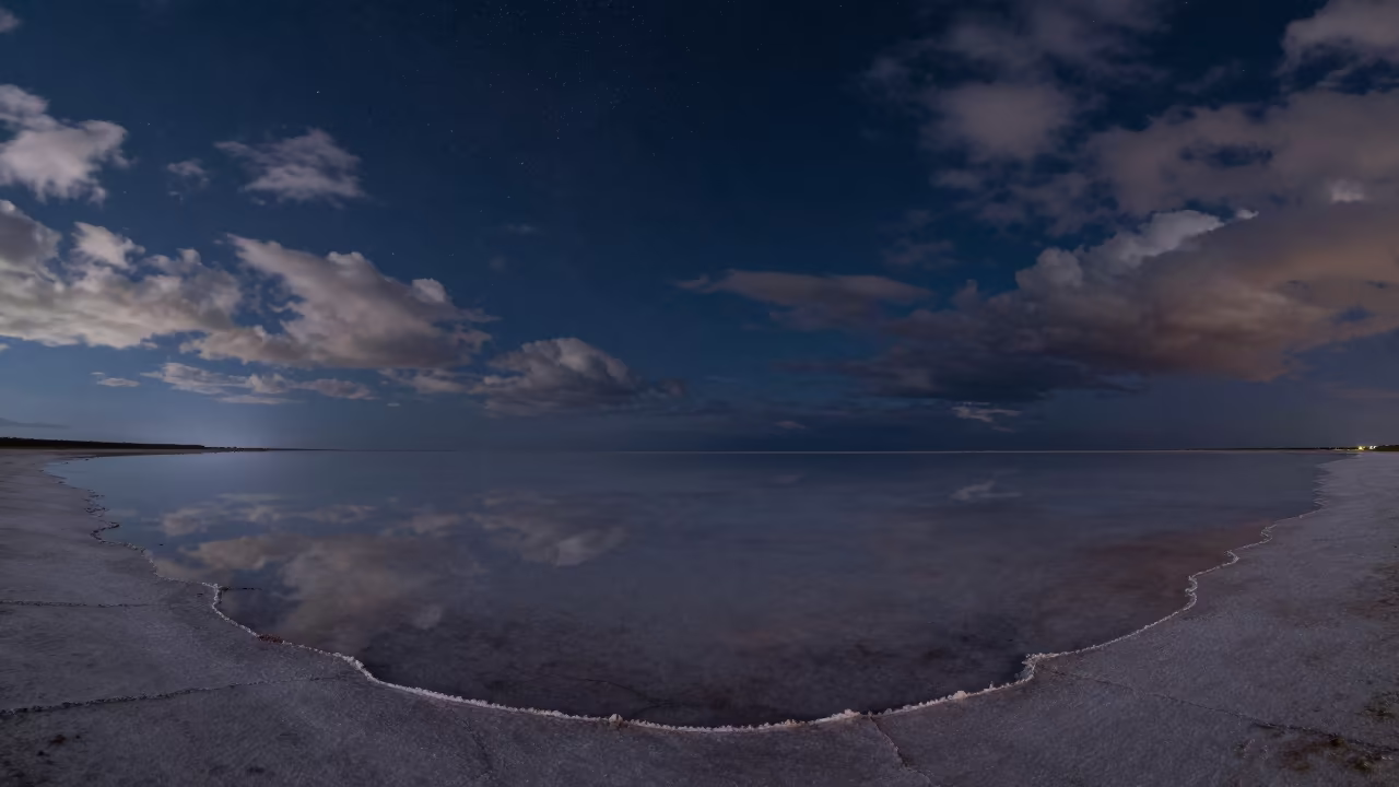 Starlit Reflection on Chelyabinsk Salt Flat in beneath thin cloud gaps and stars near Chelyabinsk