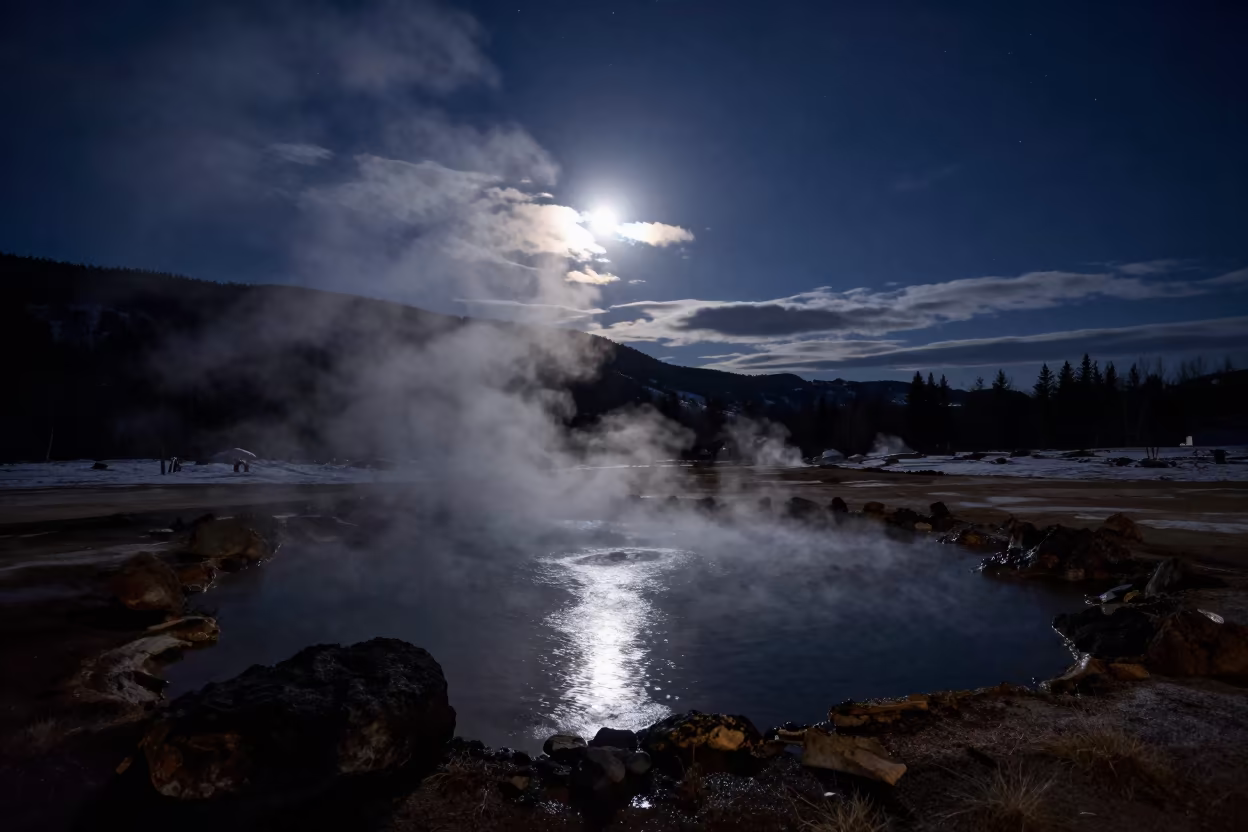 Starry Night Sky Over Austrian Hot Spring in beneath thin cloud gaps and stars in Austria