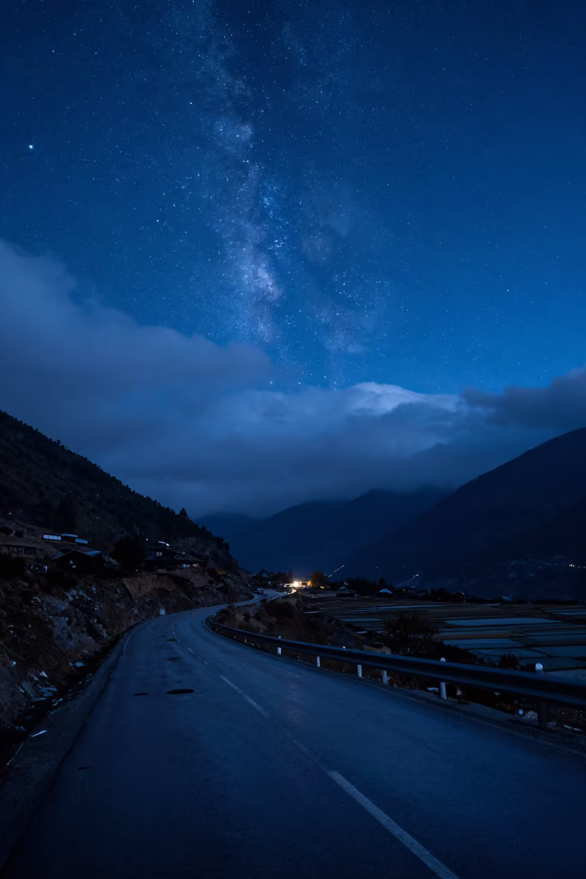 Starry Night Sky Over Winding Nepal Mountain Road in across a floodplain after rain in Nepal