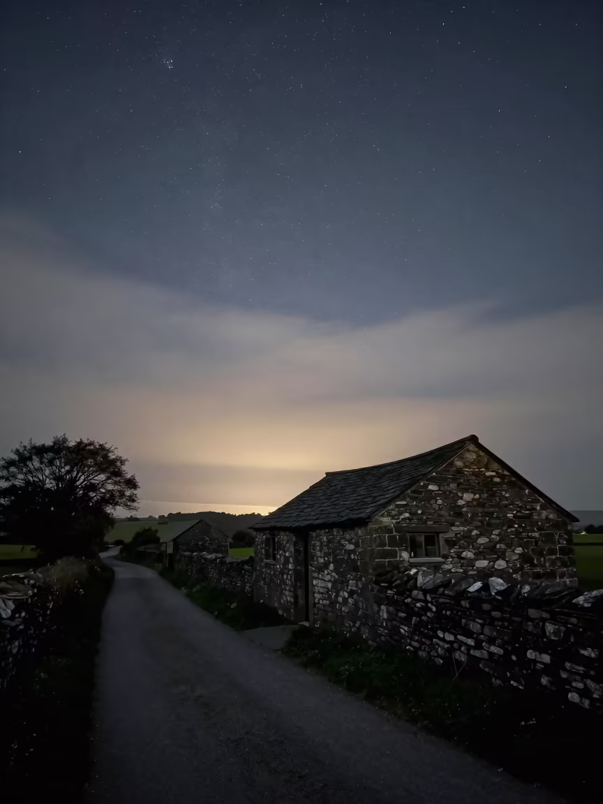 Starry Sky Over Stone Hut at Dawn in in a village lane near Warri