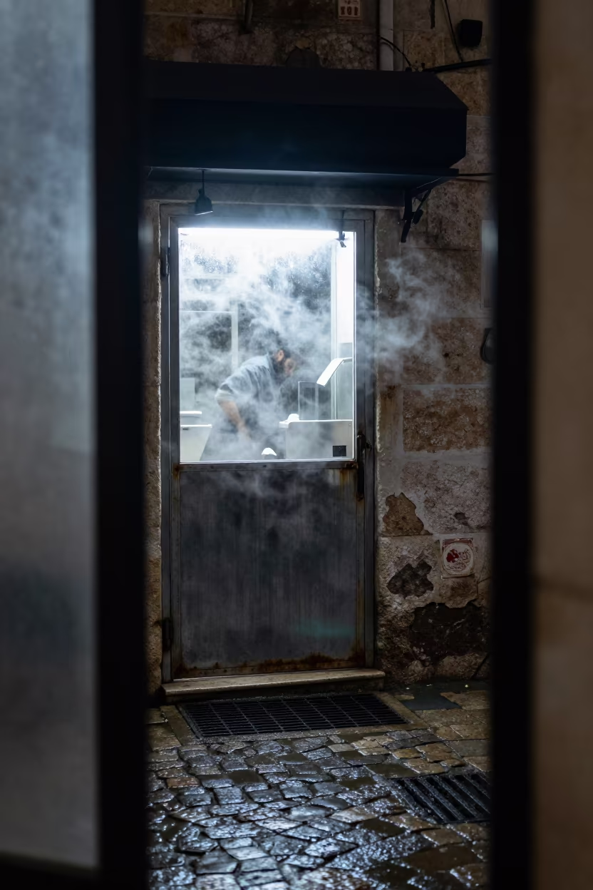 Steaming Alley Door in Predawn Haifa Winter in outside a corner cafe in Haifa