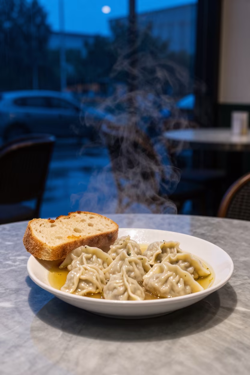 Steaming Dumplings in Broth with Bread at Blue Hour in on a marble cafe table in Bangalore
