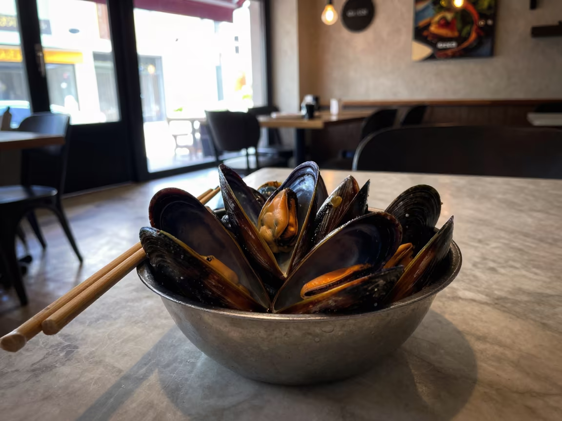 Steaming Mussels in Late Afternoon Café Light in on a marble cafe table in Santiago de Querétaro