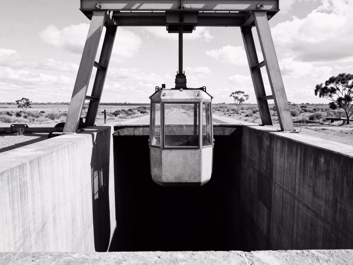Steel Cage Descending Into Dark Mine Shaft in in Australia