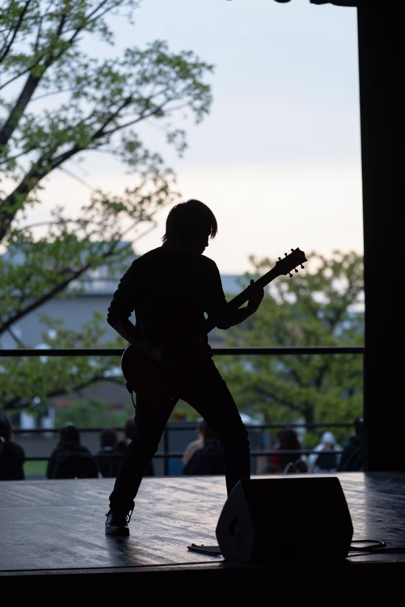 Steel Guitarist Silhouette in Chiba Dusk in on a theater stage in Chiba