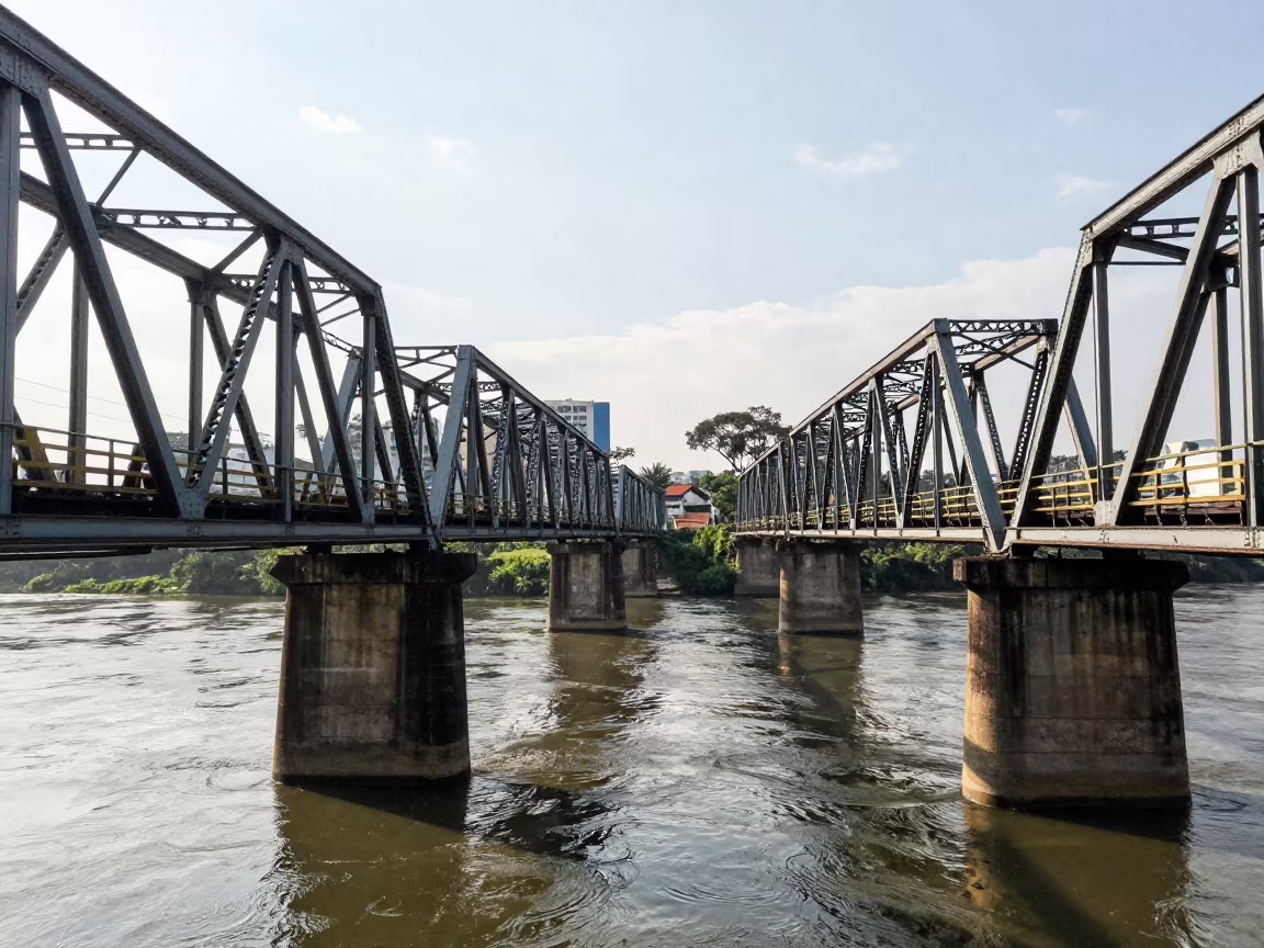 Steel Truss Bridge Shadows Over Belo Horizonte River in under a viaduct of steel and concrete in Belo Horizonte