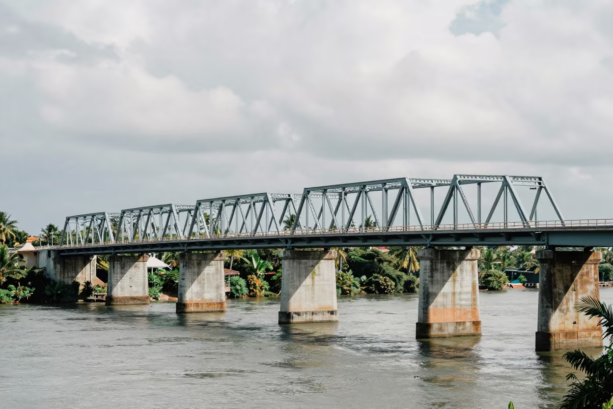 Steel Truss Bridge Shadows on Jamaican River in under a viaduct of steel and concrete in Jamaica