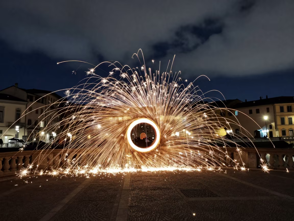 Steel Wool Sparks Spinning Under Italian Bridge in across a formal civic plaza in Italy