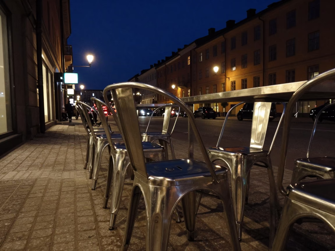 Stockholm Night Street Scene with Brushed Steel Chair and Lamp in in Stockholm, Sweden