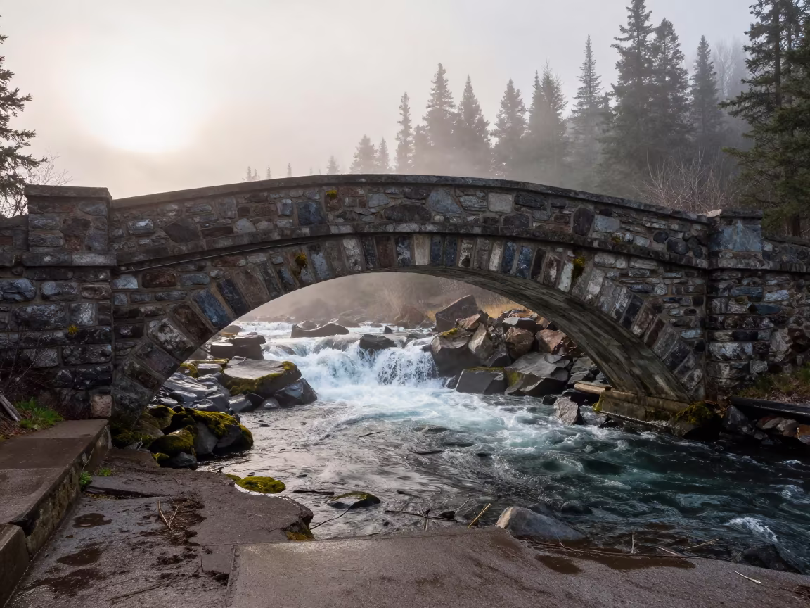 Stone Arch Bridge Over Misty Waterfall Pool Alberta in in Alberta