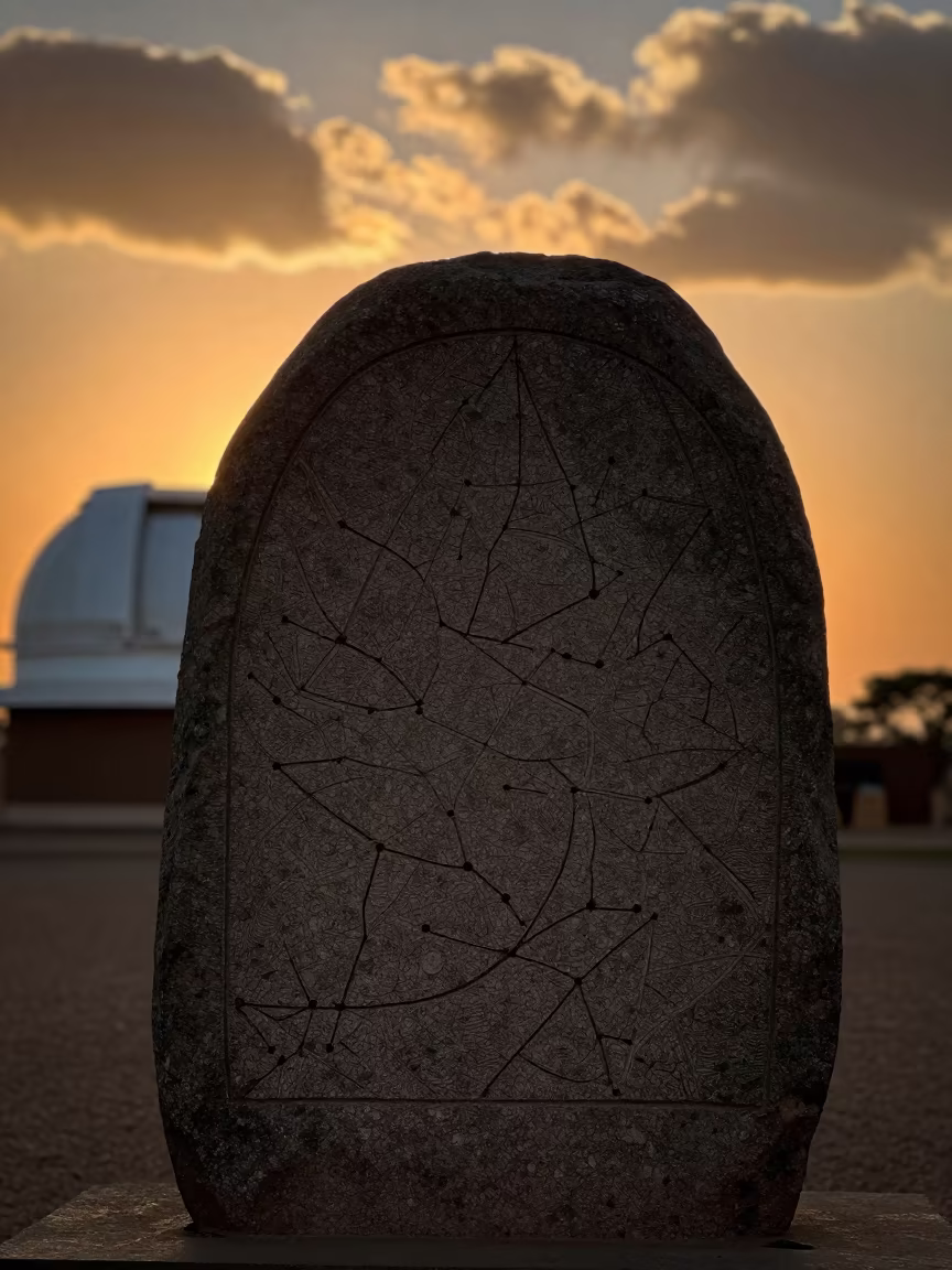 Stone Constellation Map Silhouetted at Sunset in beside an observatory dome near Nyala