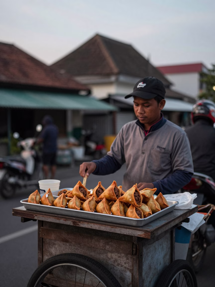 Street Vendor Selling Spiced Meat Sambusa in Yogyakarta Early Evening Light in in Yogyakarta, Indonesia