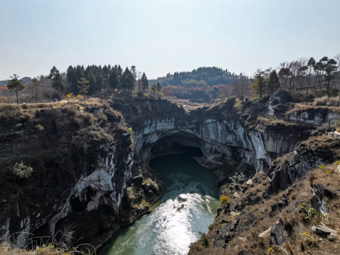Subterranean River Emerges from Cave in Guiyang Foothills in from a ridge above layered foothills near Guiyang