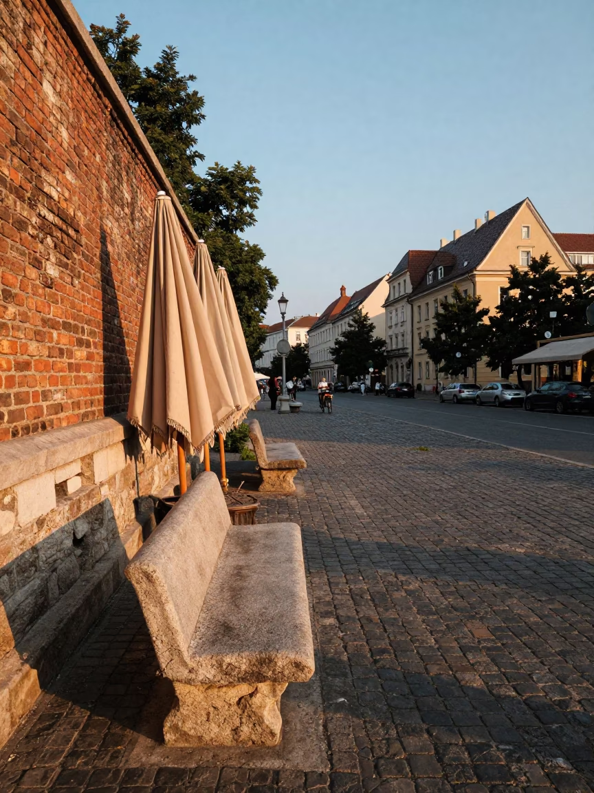 Summer Evening Street Scene in Budapest With Stone Bench And Umbrellas in in Budapest, Hungary