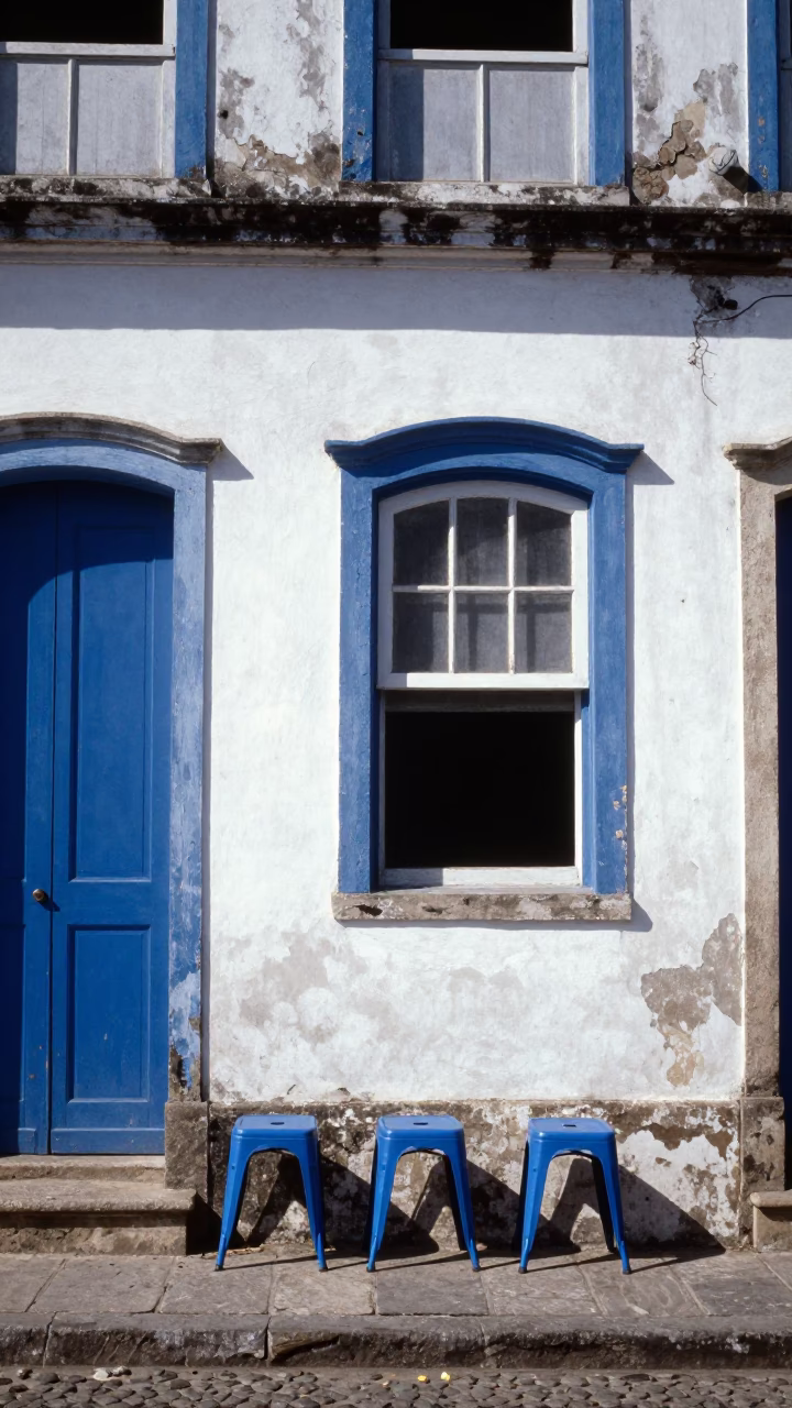 Sun-Bleached Colonial Facade and Blue Metal Stools in Salvador Bahia Brazil in in Salvador, Brazil