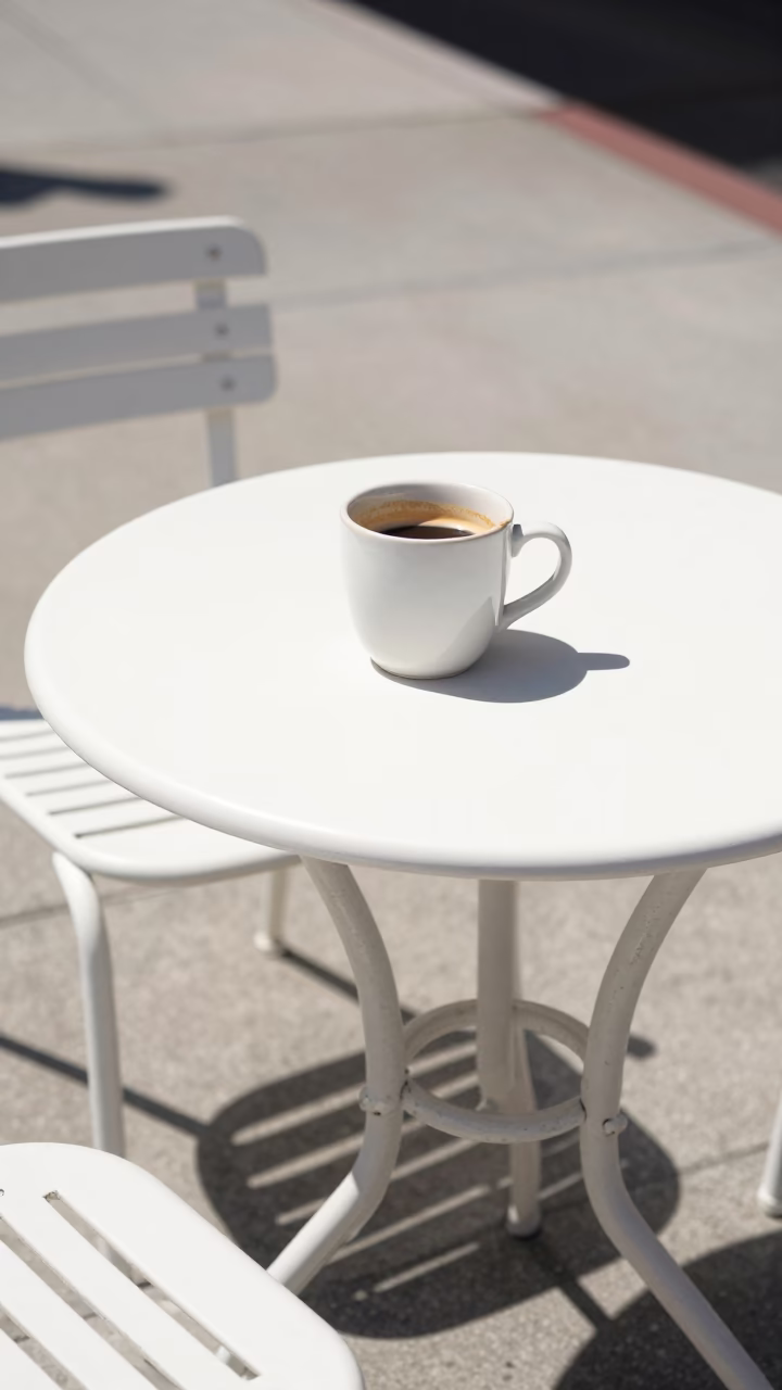 Sun-Drenched San Diego Sidewalk Cafe Table with Coffee Cup and Sunglasses in in San Diego, California, United States