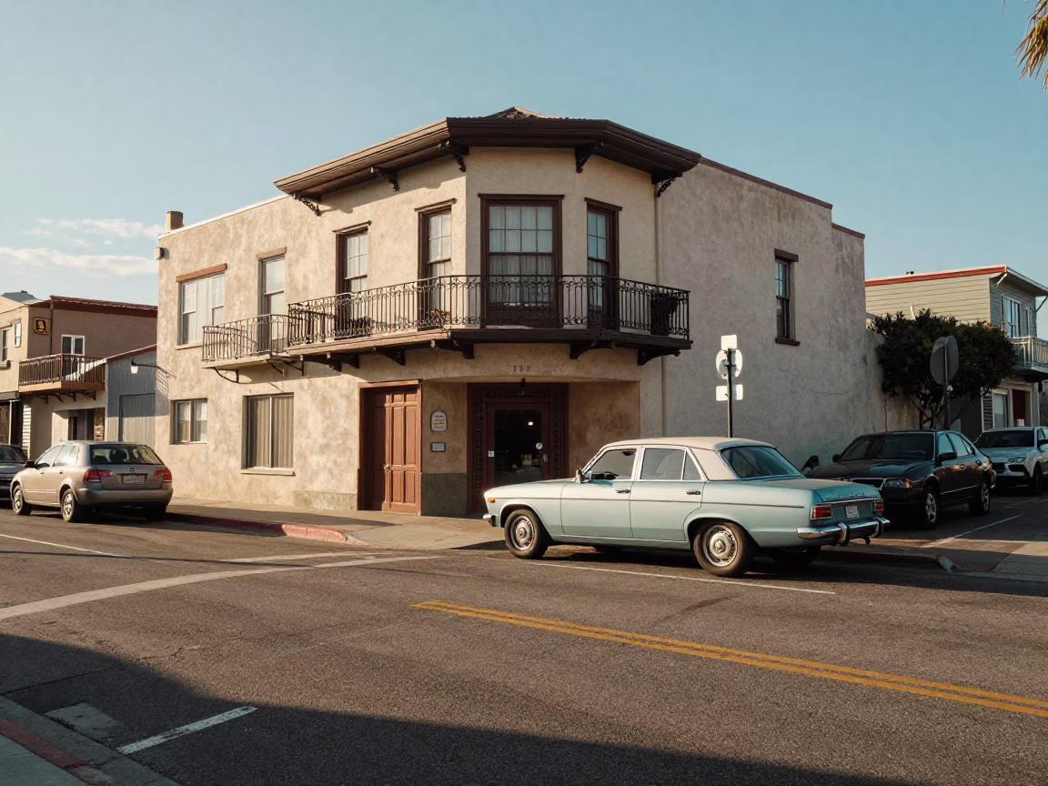 Sun-drenched San Diego street corner with vintage parked cars and historic architecture in in San Diego, California, United States