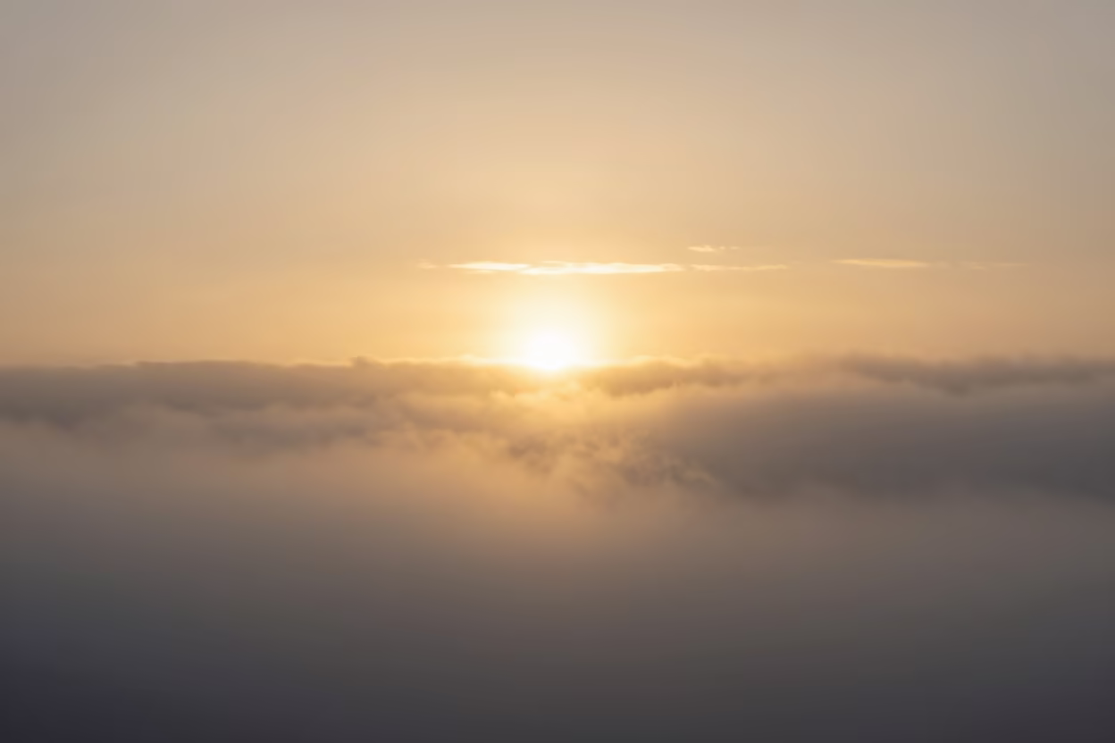 Sun Pillar Over Arctic Mist at Sunset in beneath fast-moving cloud bands near Reykjavik