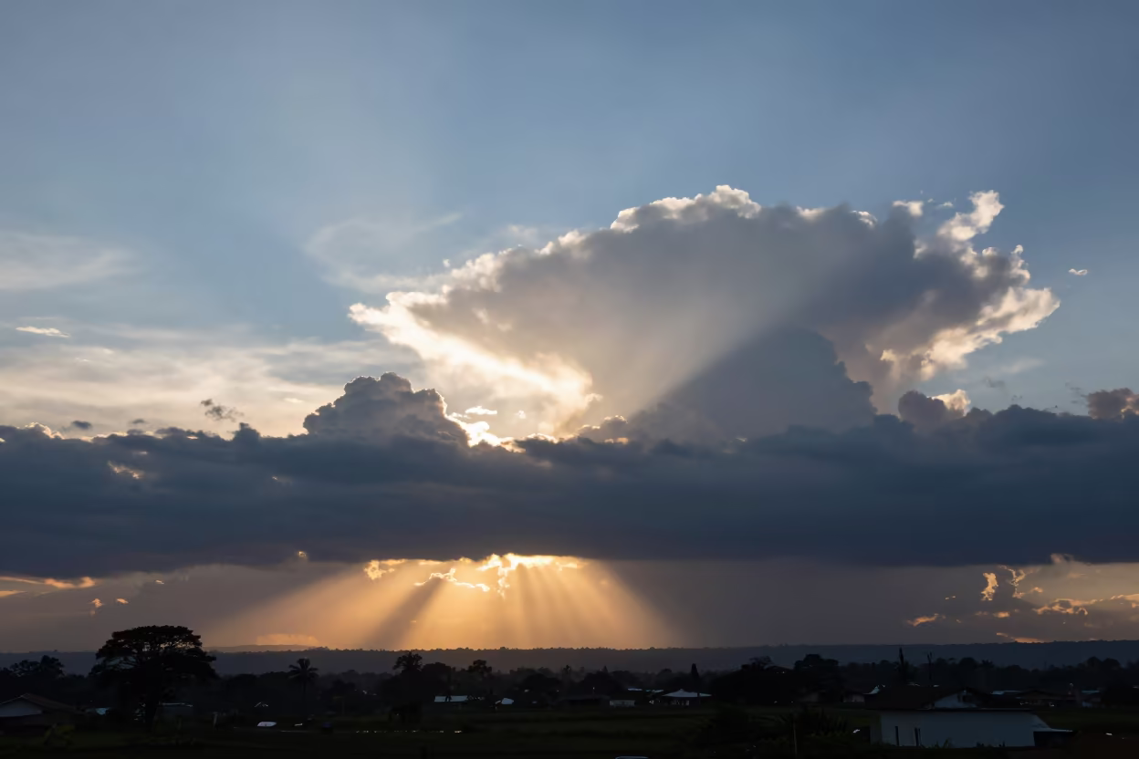 Sun Rays Break Storm Clouds Colombia in over a horizon of stacked thunderheads in Colombia