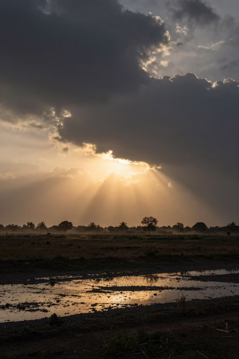 Sunlight Pierces Storm Clouds Over Aurangabad Plain in across a storm-bright plain near Aurangabad