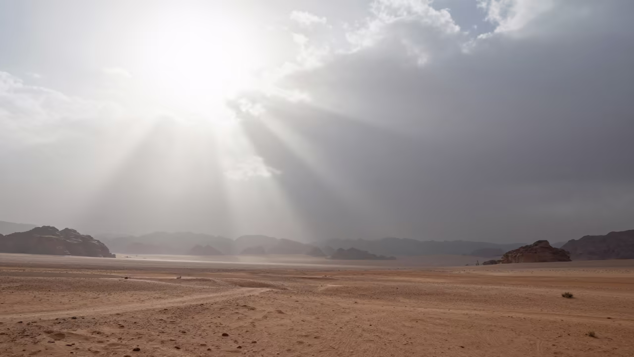 Sunlight Shafts Through Fog Over Jordan Thunderheads in over a horizon of stacked thunderheads in Jordan