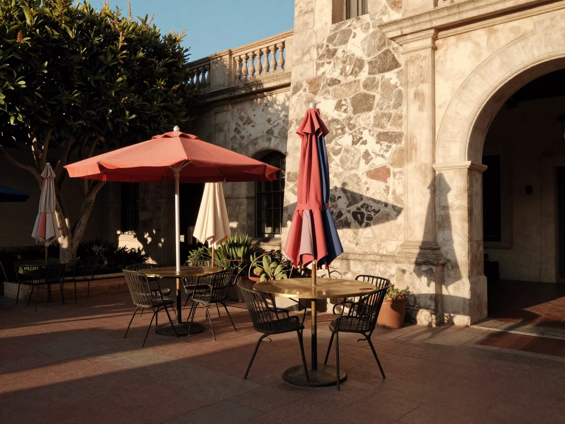 Sunlit Balboa Park Courtyard with Umbrellas and Brass Bell in in San Diego, California, United States
