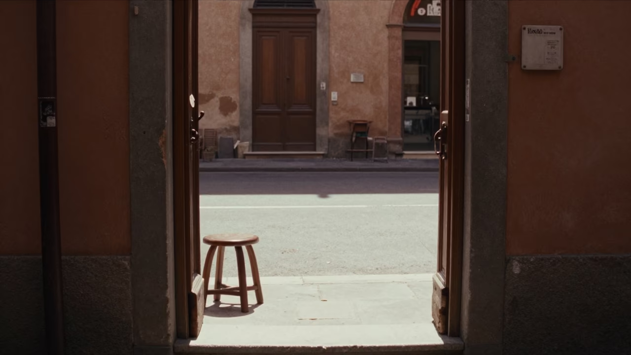 Sunlit Doorframe and Stool in Bologna Courtyard with Flat Noon Light in in Bologna, Italy