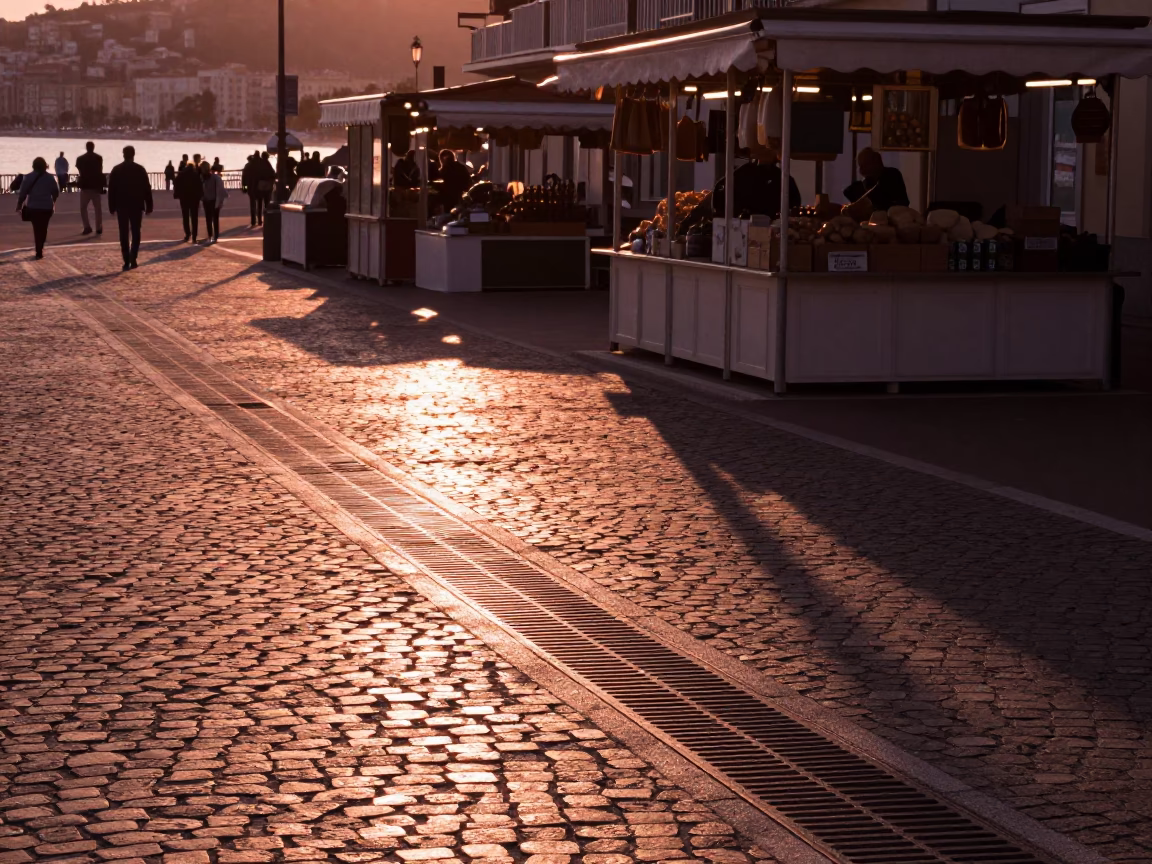 Sunlit Drainage Grate and Market Stall in Nice France Before Dusk in in Nice, France